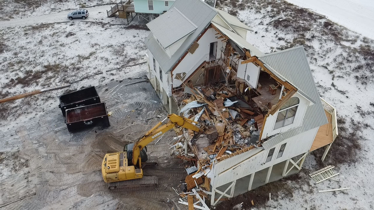 A house being taken down by excavator, Mobile County AL