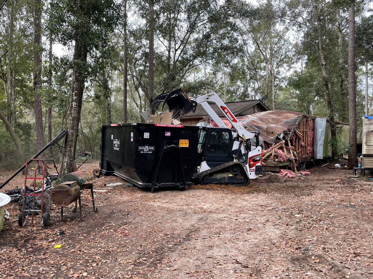 An overgrown lot being cleared and loaded, Mobile County AL