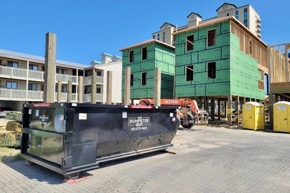 A container on the paving at a multi-story building site