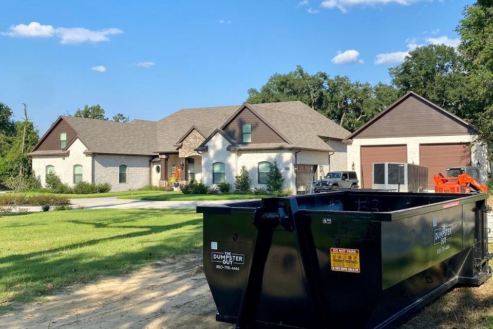 A container on the front lawn of a house