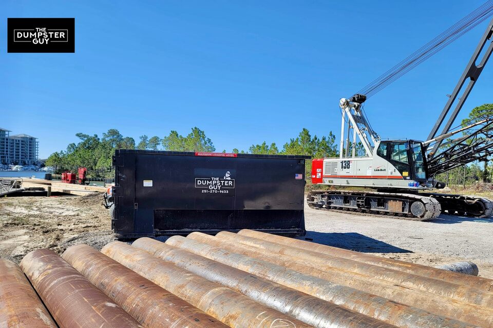 A container on a job site beside a crane