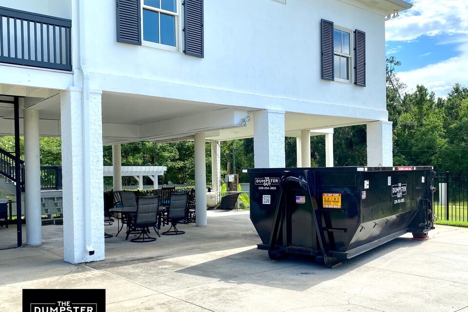 A container parked underneath a raised house
